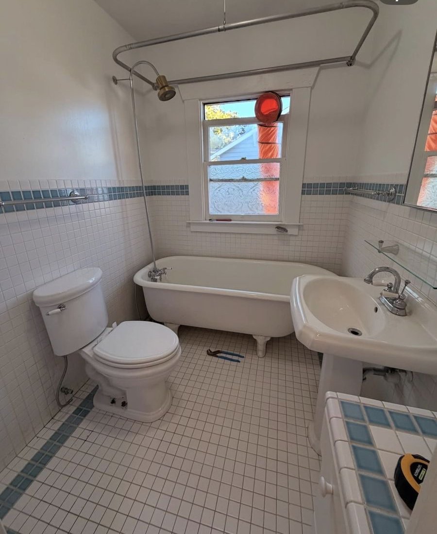 Guest bathroom before remodel — original clawfoot tub and pedestal sink