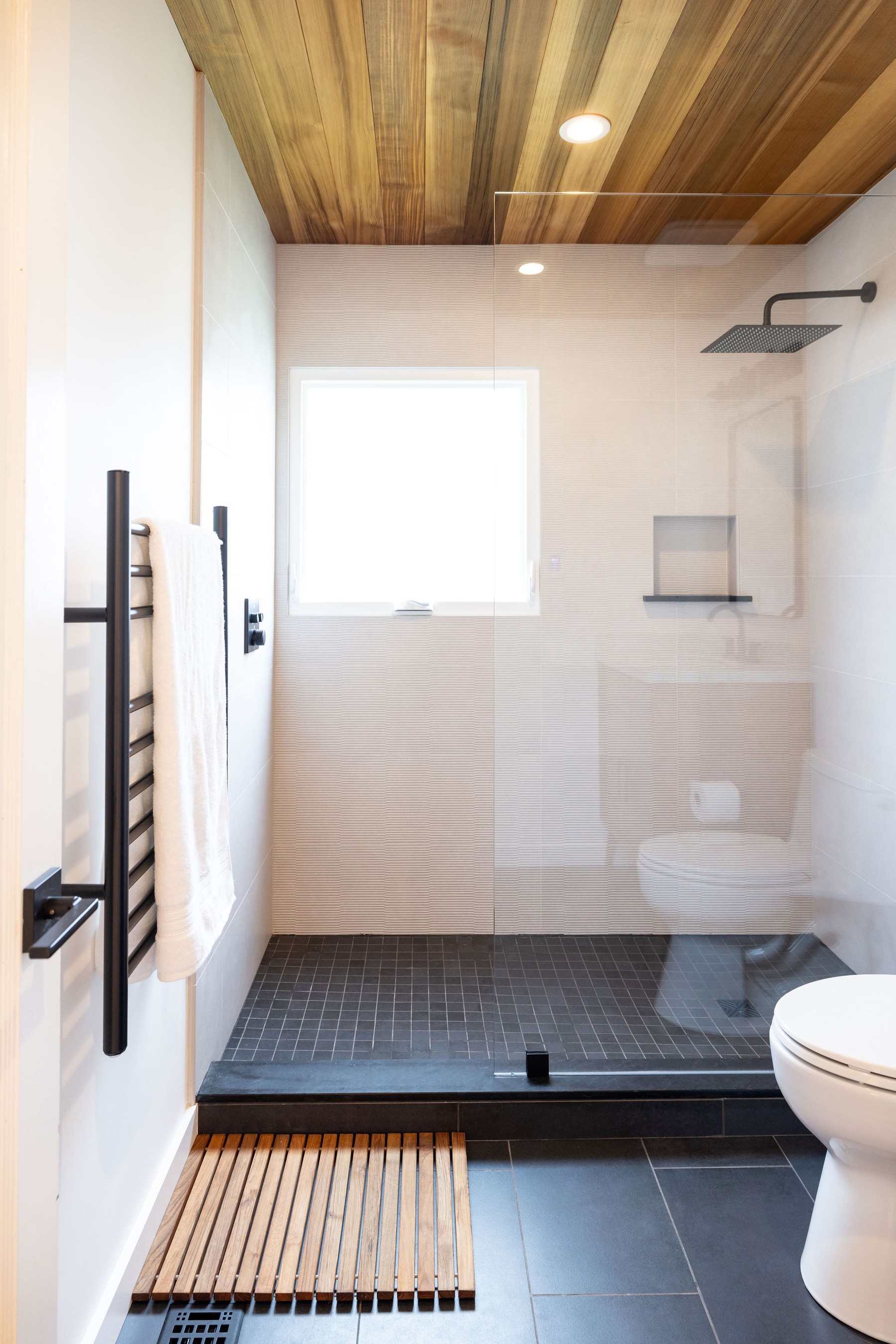 Modern walk-in shower with cedar ceiling by Build Shepherd